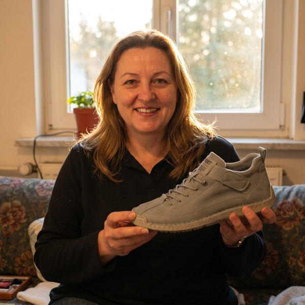 Customer holding a gray sneaker